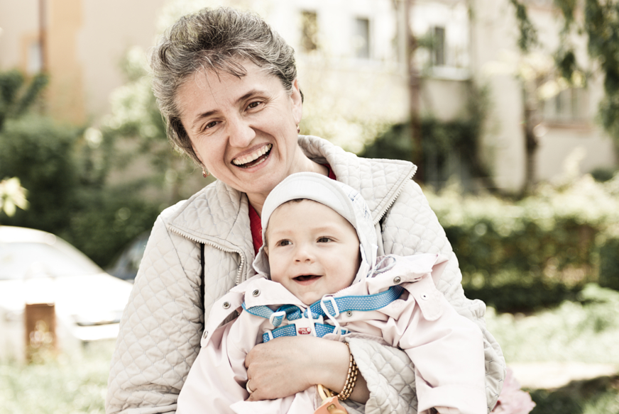 baby with mother laughing