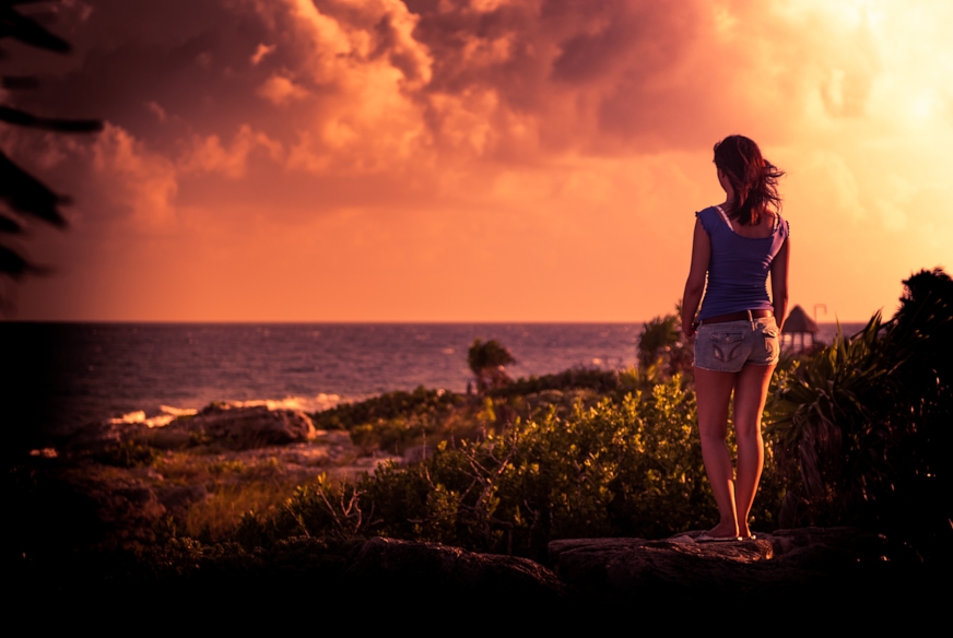 young woman overlooking the ocean